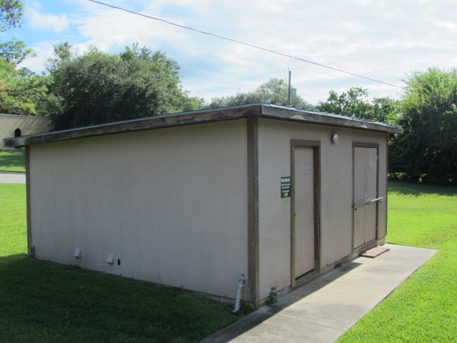 view of outbuilding with a lawn