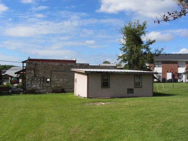 back of house with a lawn