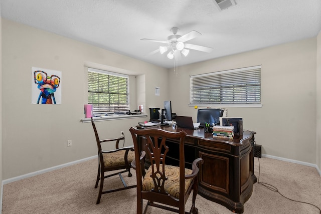 office space featuring ceiling fan, light colored carpet, and a textured ceiling