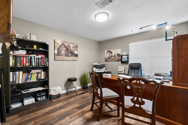 office space featuring a textured ceiling and dark hardwood / wood-style floors