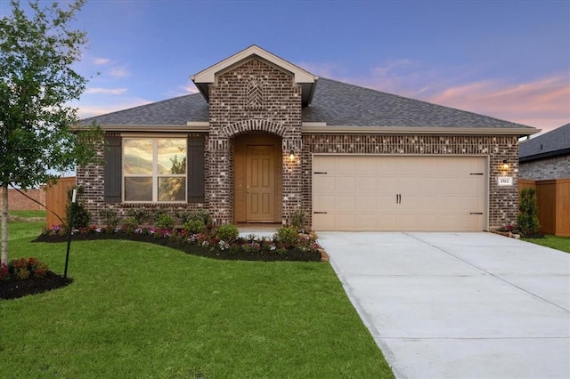 view of front facade featuring a garage, brick siding, and fence