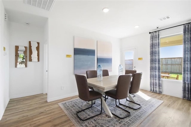 dining area with light hardwood / wood-style floors