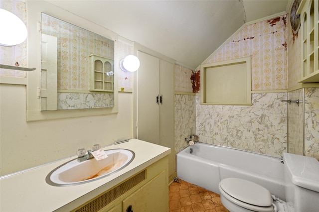 bathroom featuring wallpapered walls, a washtub, toilet, vaulted ceiling, and vanity