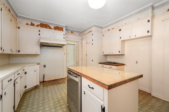 kitchen with tile patterned floors, baseboards, crown molding, and white cabinetry