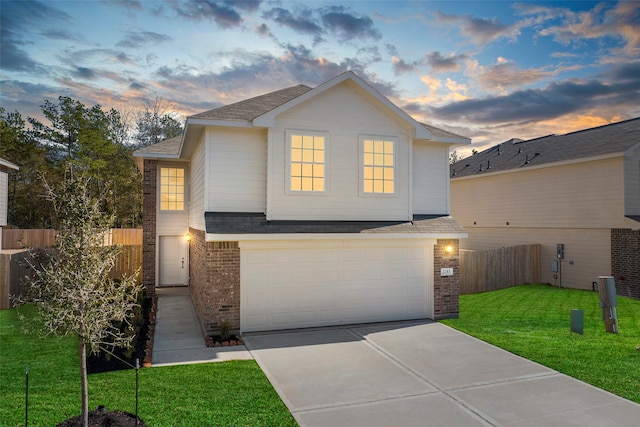 view of front of home with a lawn and a garage