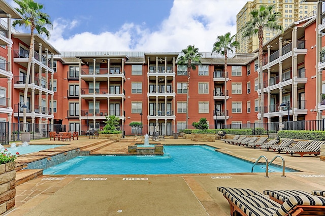 view of pool featuring pool water feature and a patio area