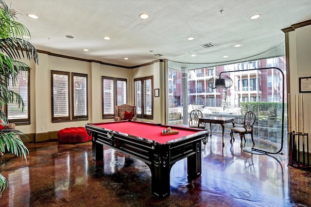 game room featuring concrete flooring, ornamental molding, and a textured ceiling