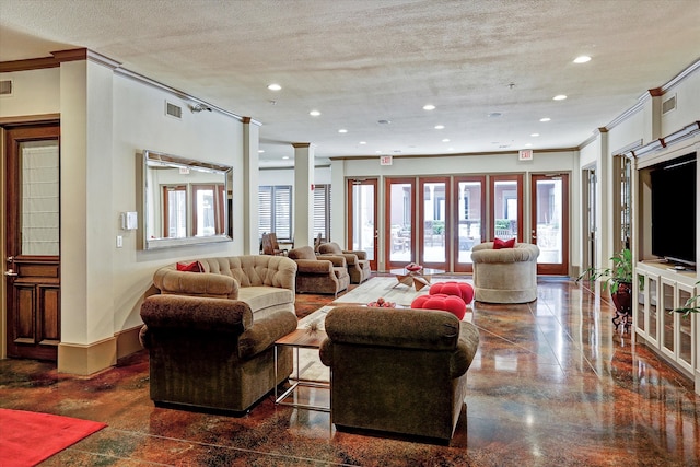 living room featuring crown molding, a textured ceiling, and ornate columns