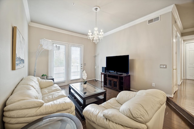 living room featuring crown molding, dark hardwood / wood-style floors, and an inviting chandelier