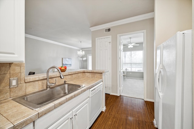 kitchen with white cabinetry, sink, decorative backsplash, crown molding, and white appliances