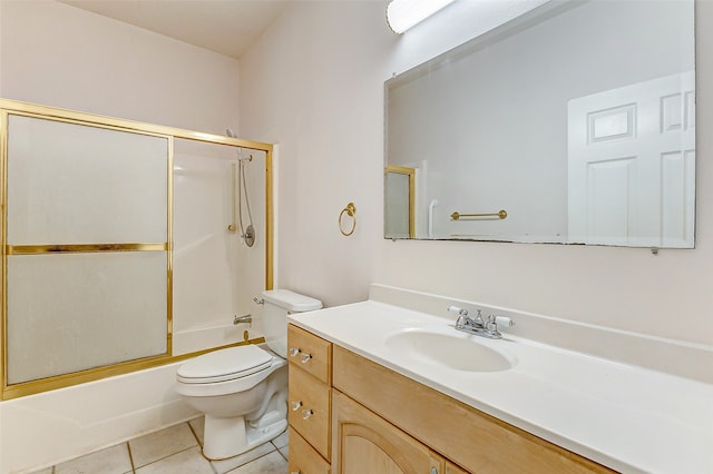 full bathroom with tile patterned floors, vanity, toilet, and combined bath / shower with glass door