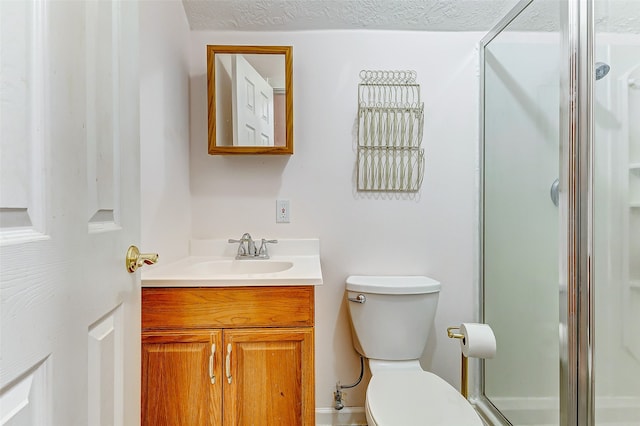 bathroom featuring vanity, walk in shower, toilet, and a textured ceiling