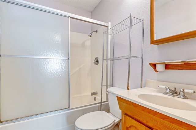 full bathroom with shower / bath combination with glass door, vanity, toilet, and a textured ceiling