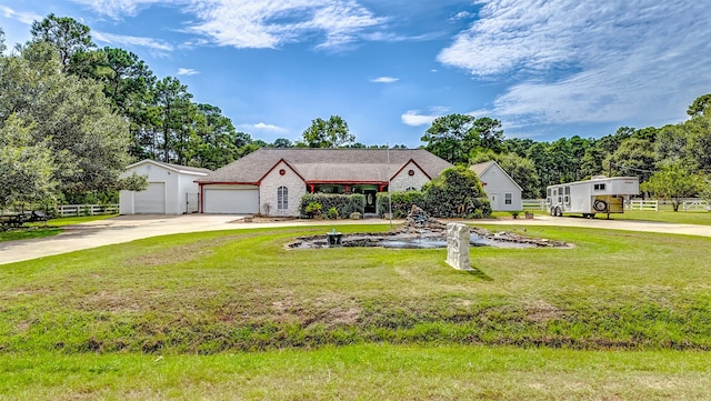 view of front of property featuring a garage and a front lawn