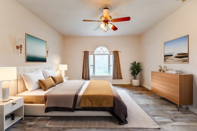 bedroom featuring ceiling fan and dark wood-type flooring