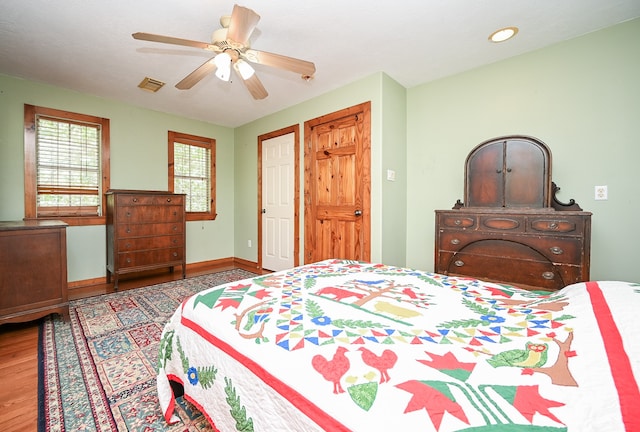 bedroom featuring hardwood / wood-style floors and ceiling fan