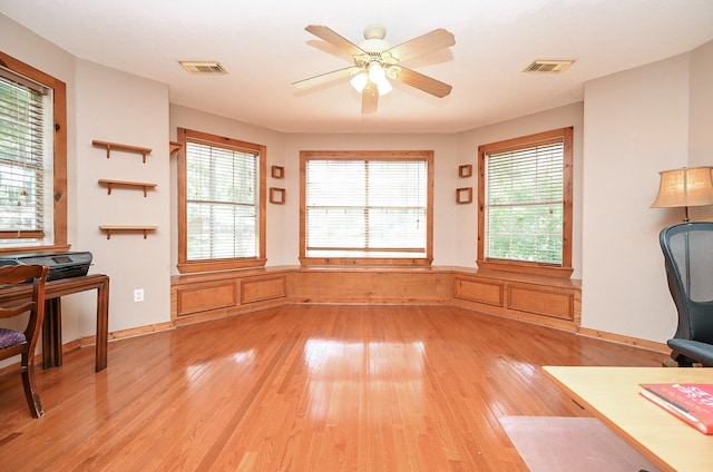 interior space with a healthy amount of sunlight, ceiling fan, and light hardwood / wood-style floors