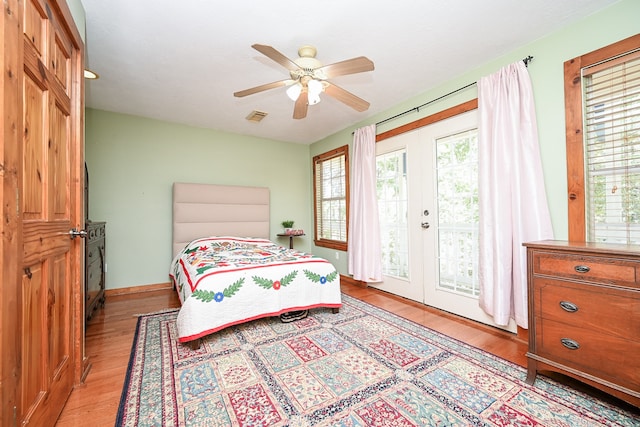 bedroom with light hardwood / wood-style flooring, ceiling fan, and access to outside