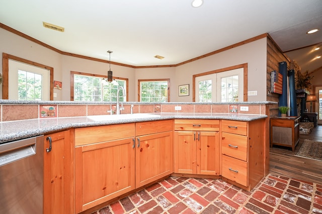 kitchen featuring crown molding, dishwasher, sink, and hardwood / wood-style floors