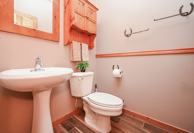 bathroom with toilet and wood-type flooring