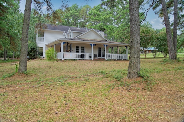 farmhouse inspired home with a porch and a front lawn