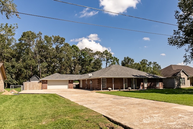 ranch-style home with a garage and a front lawn