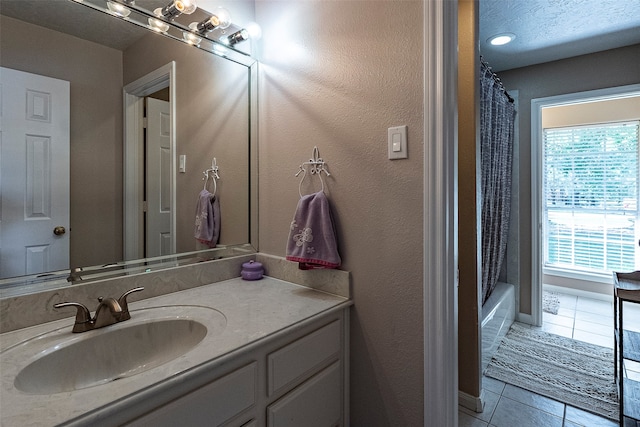 bathroom with shower / tub combo, tile patterned flooring, and vanity