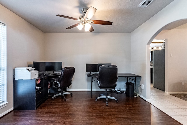 office area with a healthy amount of sunlight, ceiling fan with notable chandelier, a textured ceiling, and hardwood / wood-style floors