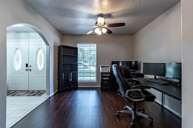 office space with a textured ceiling, dark hardwood / wood-style floors, and ceiling fan