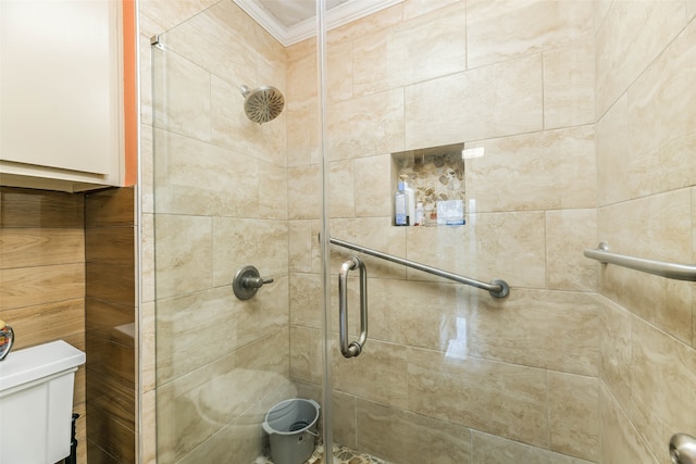 bathroom with crown molding, toilet, and an enclosed shower