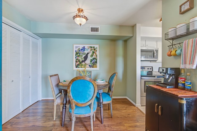 dining space featuring light wood-type flooring