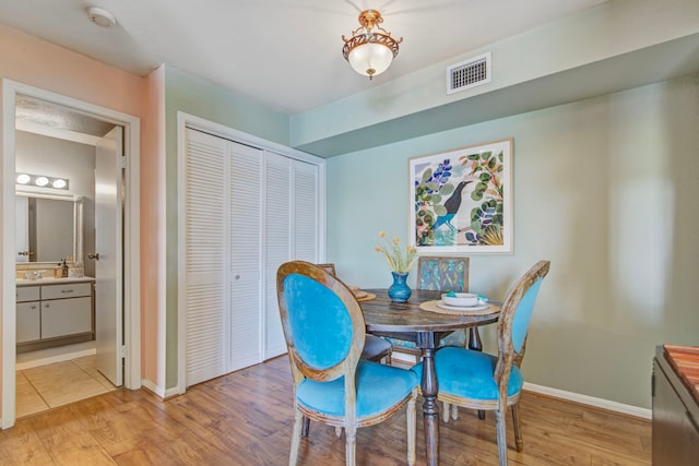 dining room featuring light wood-type flooring and sink