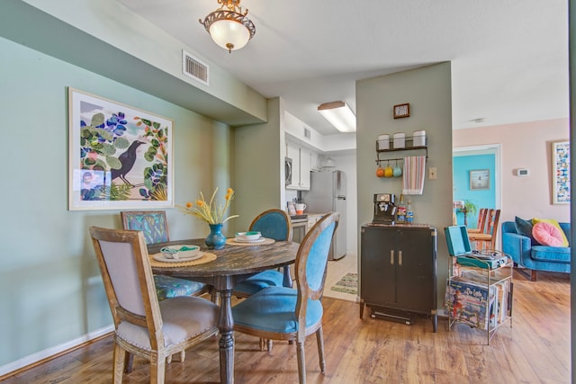 dining area with light wood-type flooring