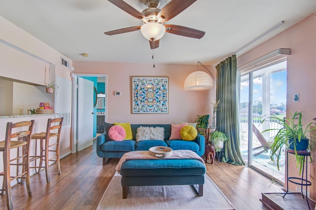 living room with ceiling fan and light hardwood / wood-style floors