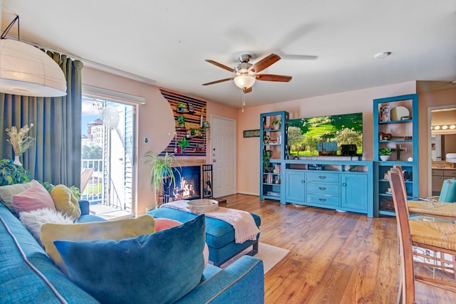 living room with light hardwood / wood-style flooring and ceiling fan