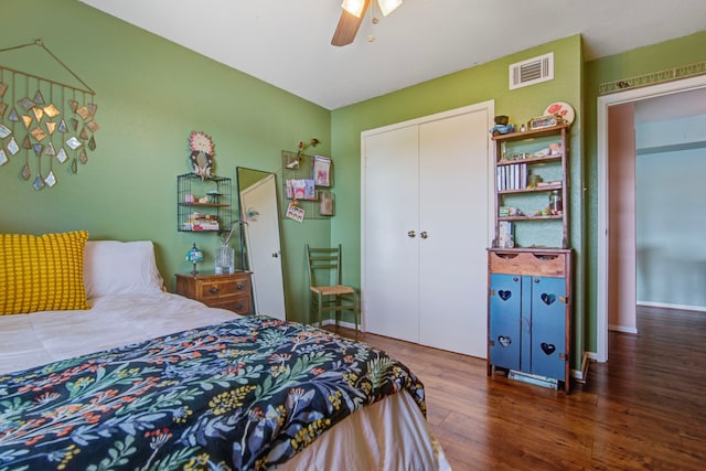 bedroom featuring ceiling fan, a closet, and dark wood-type flooring