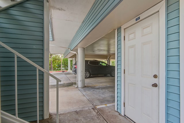 view of exterior entry with a carport