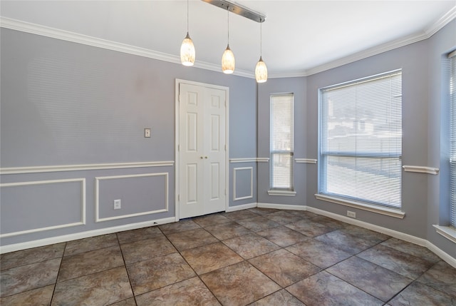 unfurnished dining area featuring dark tile patterned floors and ornamental molding