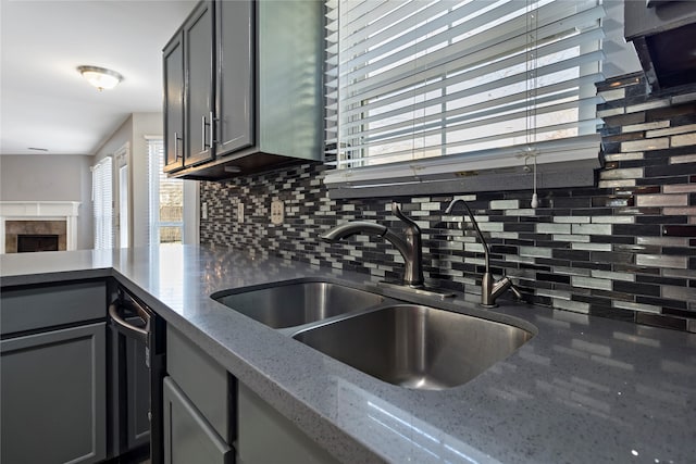 kitchen featuring plenty of natural light, backsplash, and sink