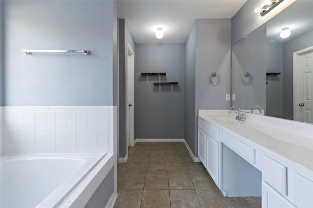 bathroom with vanity, tile patterned flooring, and tiled bath