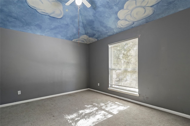 spare room featuring carpet flooring and ceiling fan