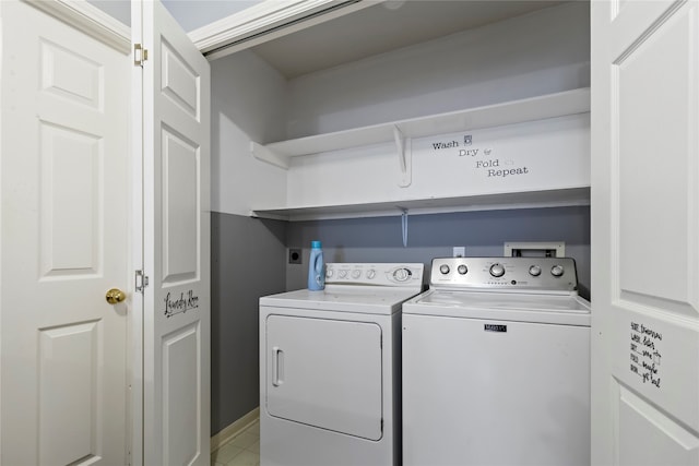 laundry room featuring independent washer and dryer and light tile patterned flooring