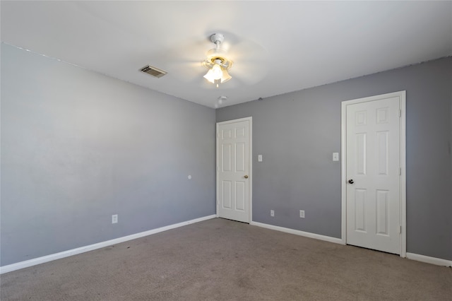 empty room with ceiling fan and carpet