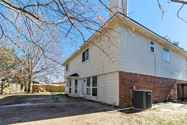 rear view of house featuring central AC and a patio