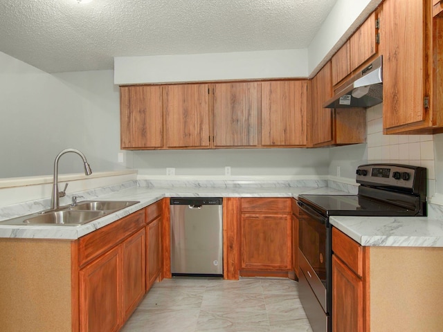 kitchen with a textured ceiling, exhaust hood, sink, and appliances with stainless steel finishes