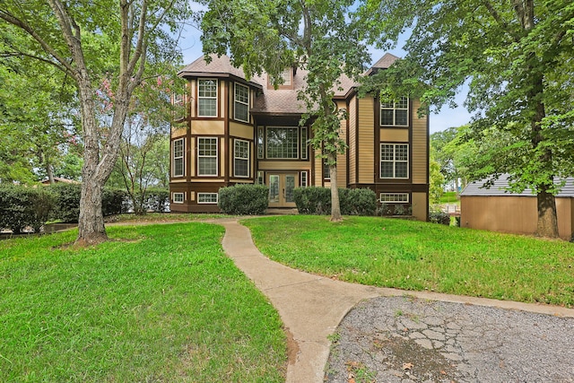 back of property featuring a lawn