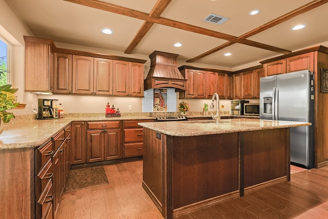 kitchen featuring custom range hood, stainless steel appliances, sink, dark hardwood / wood-style floors, and an island with sink