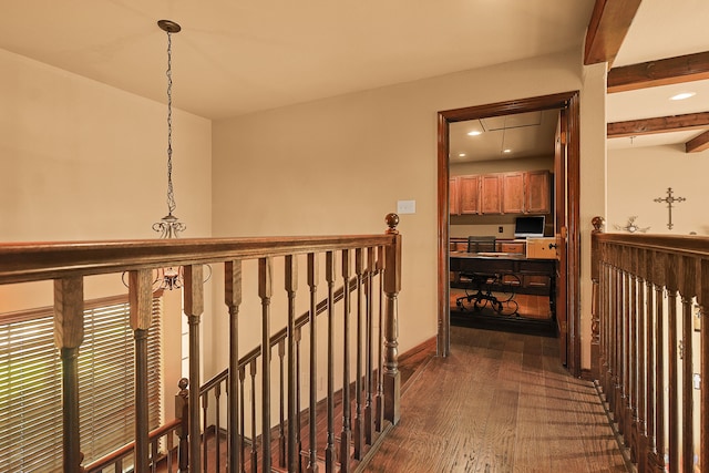 hallway featuring dark wood-type flooring and beamed ceiling