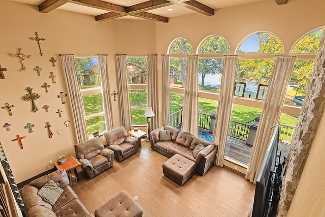 living room featuring beamed ceiling and light wood-type flooring