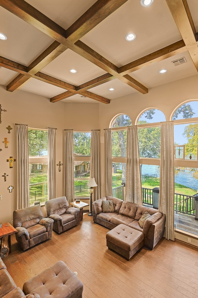 living room featuring light hardwood / wood-style flooring, coffered ceiling, and beam ceiling